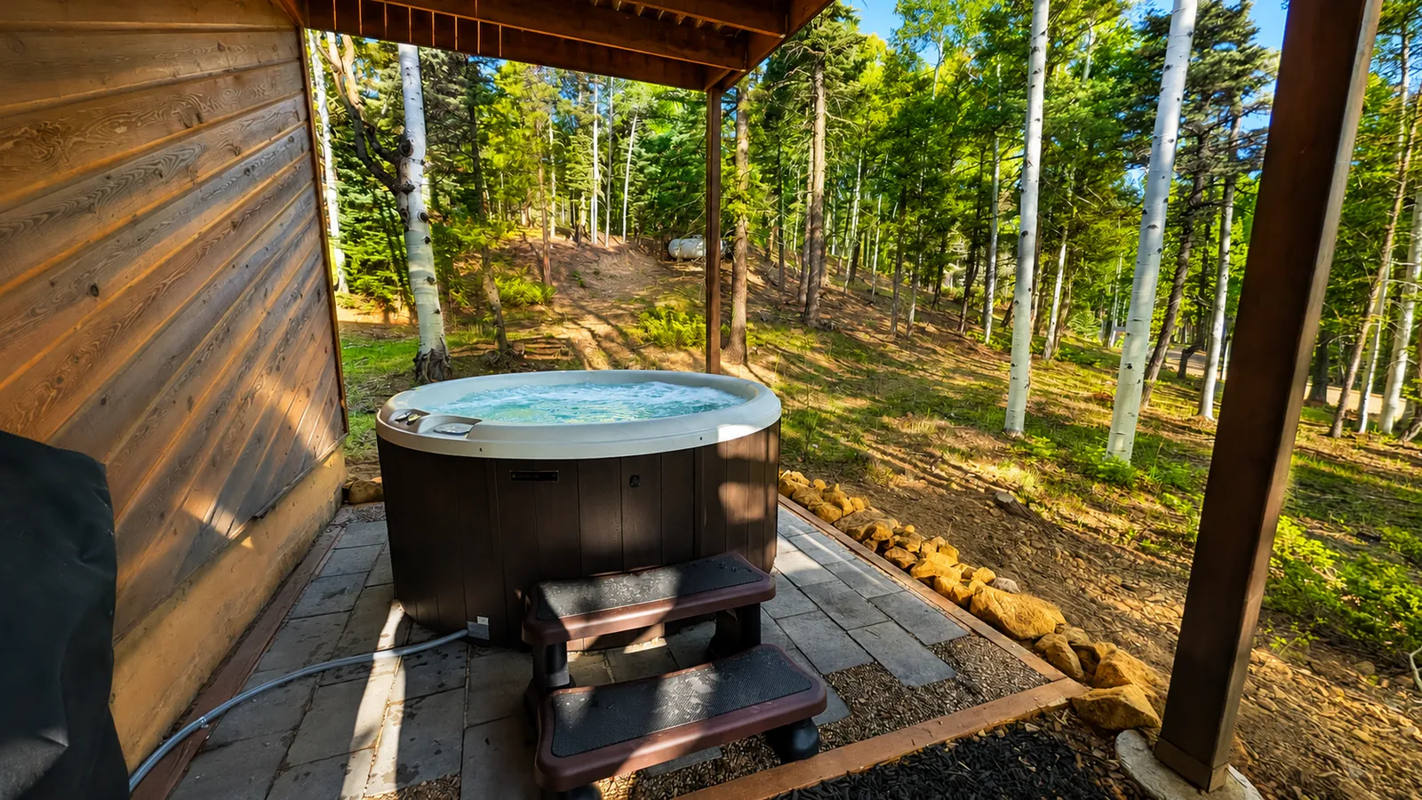 Hot tub with steps under the covered deck